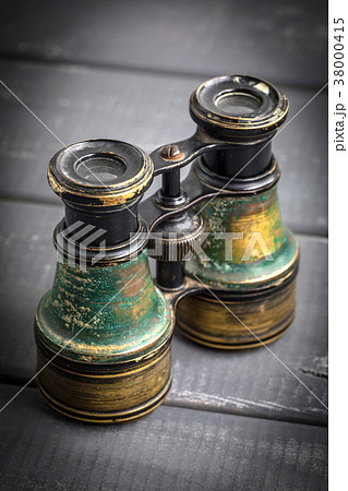 Old binoculars covered with patina. Old binoculars covered with patina. 38000415