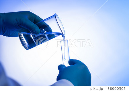 scientist pours liquid 38000505