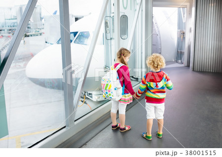 Kids travel and fly. Child at airplane in airport Kids travel and fly. Child at airplane in airport 38001515