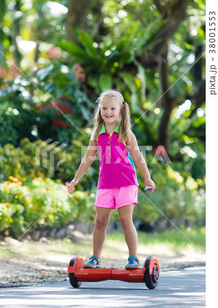 Child on hover board. Kids ride scooter. 38001553