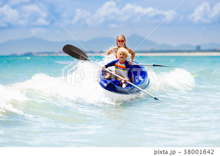 Kids kayaking in ocean. Children in kayak in sea Kids kayaking in ocean. Children in kayak in sea 38001642