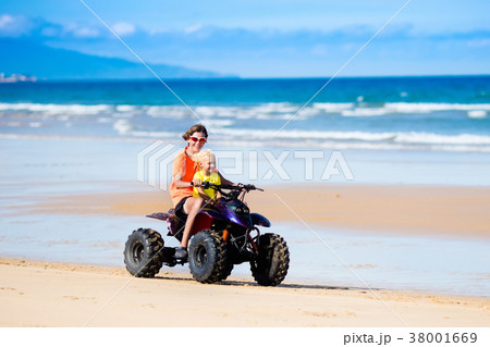Kids on quad bike. Off road all terrain vehicle. 38001669