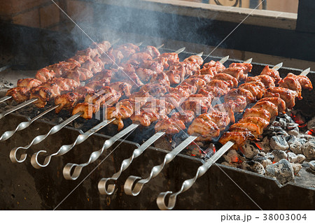 Cooking of a shashlik on a grill on a metal skewer 38003004