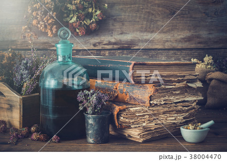 Tincture bottles, healthy herbs, old books, mortar Tincture bottles, healthy herbs, old books, mortar 38004470