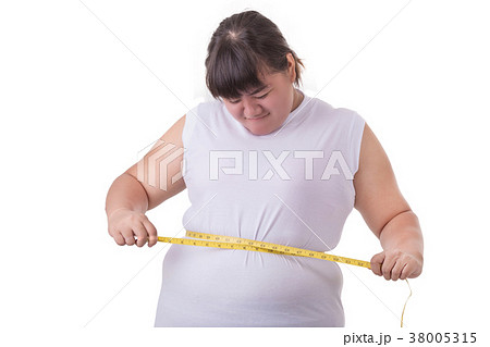 Fat Asian woman wear white t-shirt and checking her body size with measurement tape isolated on white 38005315