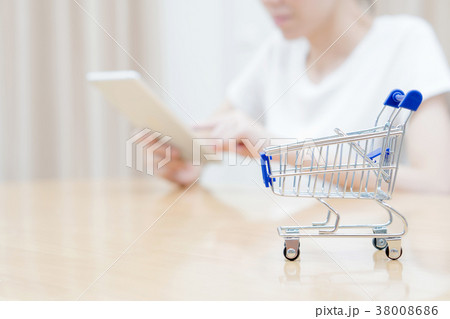Woman shopping at the desk with miniature trolley Woman shopping at the desk with miniature trolley 38008686