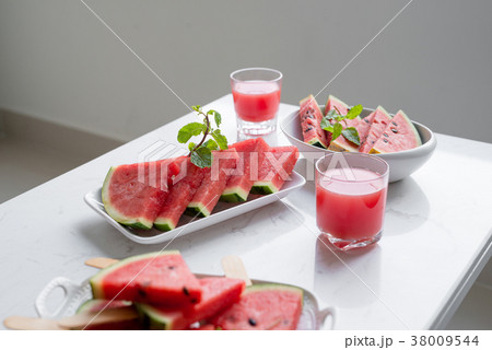 Fresh red smoothie in a glass with sliced pieces 38009544