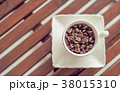 Coffee cup and coffee beans on wooden background 38015310
