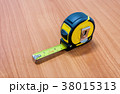 Measuring tape on table wood 38015313
