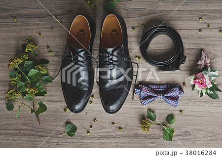 Belt, tie, shoes and a boutonniere on the table Belt, tie, shoes and a boutonniere on the table 38016284