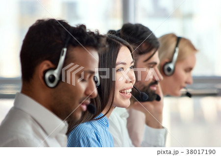 Four support phone operators at workplace. Four support phone operators at workplace. 38017190