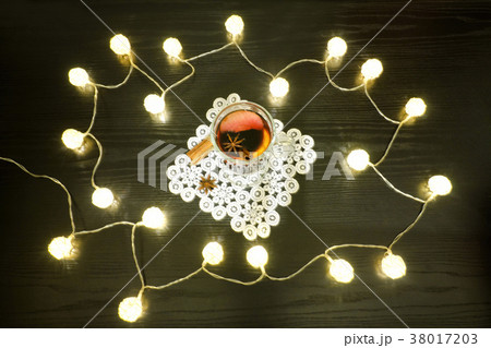 Mulled wine with spices on a lacy napkin Mulled wine with spices on a lacy napkin 38017203
