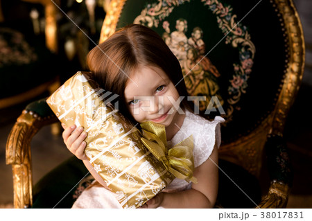 little smiling girl with christmas gift box. little smiling girl with christmas gift box. 38017831