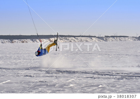 A male athlete engaged in snow kiting 38018307
