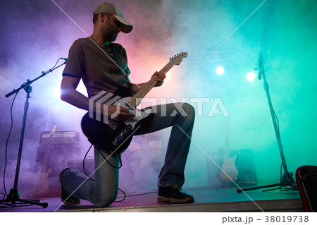 The guitarist performs on stage. The guitarist performs on stage. 38019738