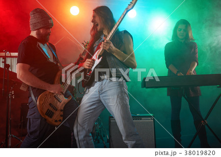 Guitarist and bass player perform on stage. 38019820