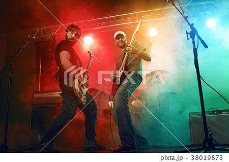 Guitarist and bass player perform on stage. 38019873