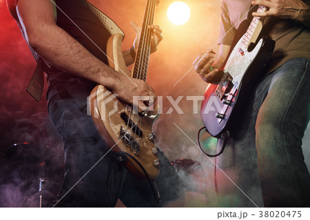 Guitarist and bass player perform on stage. Guitarist and bass player perform on stage. 38020475