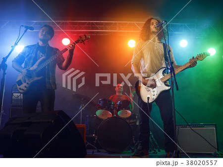 Rock band performs on stage. 38020557