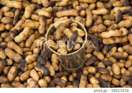 Steel glass full with fried groundnuts for sale 38021016