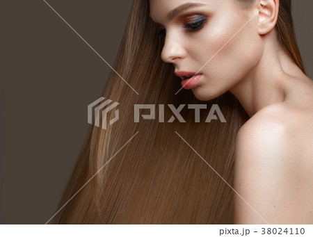 Beautiful blond girl with a perfectly smooth hair Beautiful blond girl with a perfectly smooth hair 38024110
