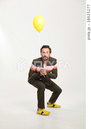 Happy man with yellow balloon 38025277