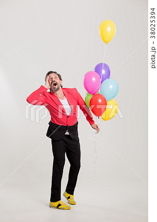 man in red jacket with colorful balloons man in red jacket with colorful balloons 38025394