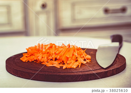 Cut carrot on wooden board and knife 38025610