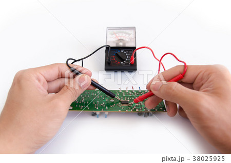 Technician hand with multimeter probes repairing Technician hand with multimeter probes repairing 38025925