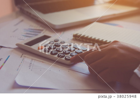 Man hand using a financial calculator with laptop Man hand using a financial calculator with laptop 38025948