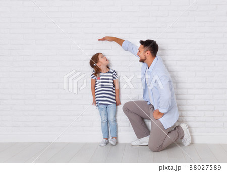 concept of the family. the father measures growth of child to da concept of the family. the father measures growth of child to da 38027589