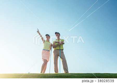 Silhouette of a man pointing while standing next 38028539