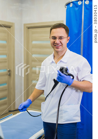 proctologist holding anoscope at hospital ward proctologist holding anoscope at hospital ward 38030415