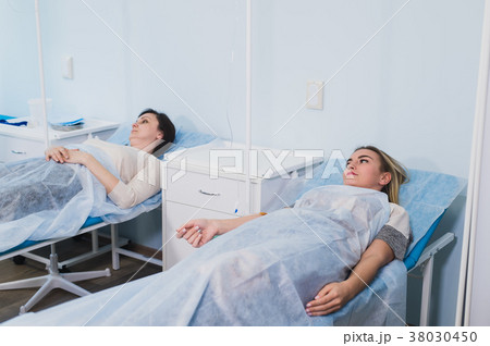 Female patient resting in medical bed at the Female patient resting in medical bed at the 38030450