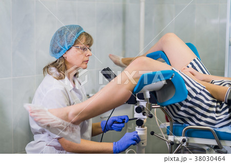 Senior female positively gynecologist examining a 38030464
