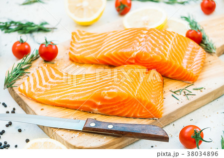 Raw and fresh salmon meat fillet on wooden cutting board 38034896