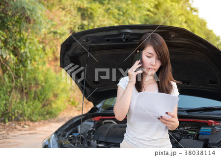 Young woman sitting try to calling for assistance  38038114