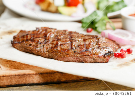 steak of marble beef, grilled. Serving on a wooden 38045261