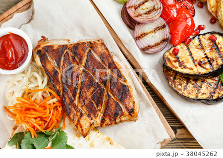 pork steak grill. Serving on a wooden Board on a 38045262