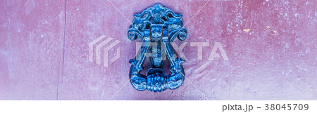 Door with brass knocker in the shape of a decor 38045709