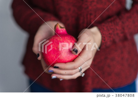 The fruit of the pomegranate in the womens hands The fruit of the pomegranate in the womens hands 38047808