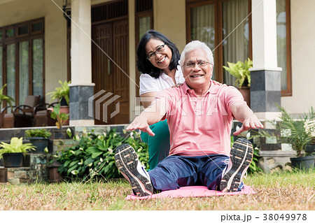Cheerful senior woman helping her partner during 38049978