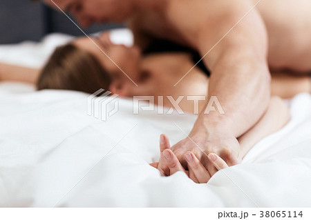 Focused on hands of passion couple having sex. 38065114