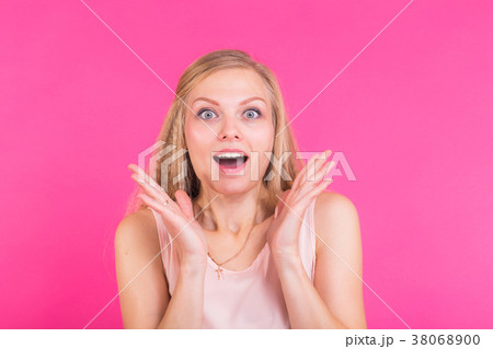 Surprised young woman over pink background 38068900