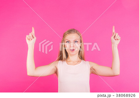 Pretty woman pointing up on pink copy space 38068926