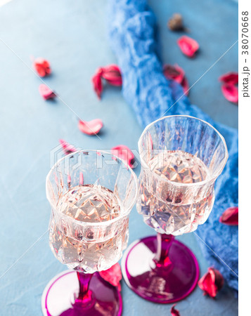 Two stemmed glasses with champagne on blue Two stemmed glasses with champagne on blue 38070668