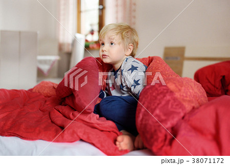 Cute little boy in pajamas having fun in bed  38071172