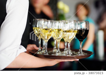 Waitress holding champagne and wine glasses dish 38073023