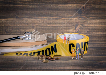health care and medical background. yellow caution tape on a wood health care and medical background. yellow caution tape on a wood 38075499