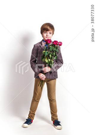 Smiling boy with a bouquet of red roses Smiling boy with a bouquet of red roses 38077330